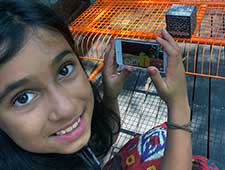 Girl smiling with her Merge Cube app at coding camp
