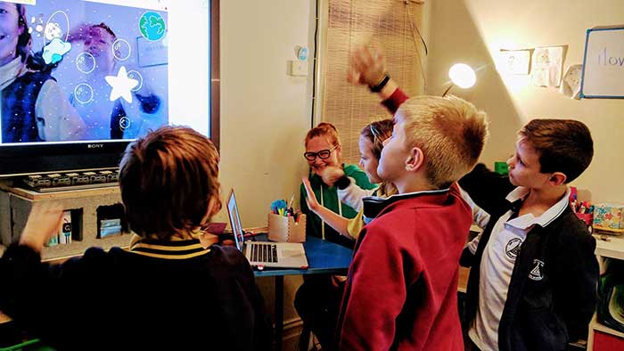 Playing a video sensing game during our kids coding classes
